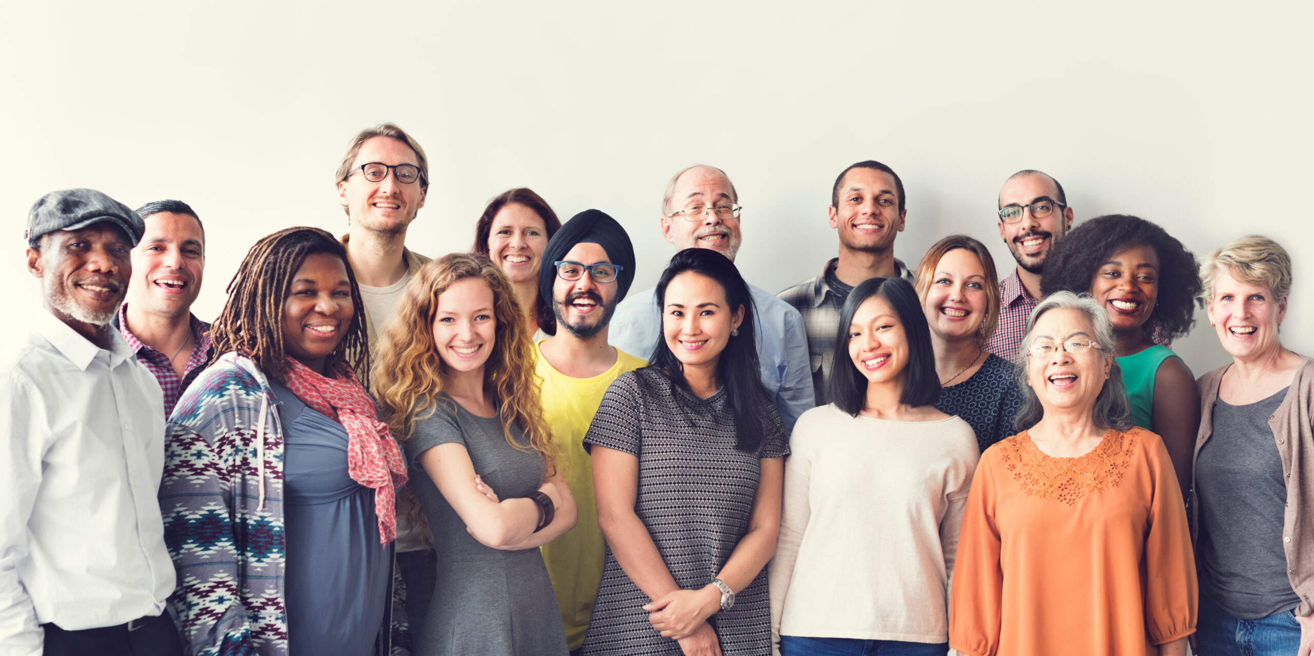 A diverse group of people standing and smiling