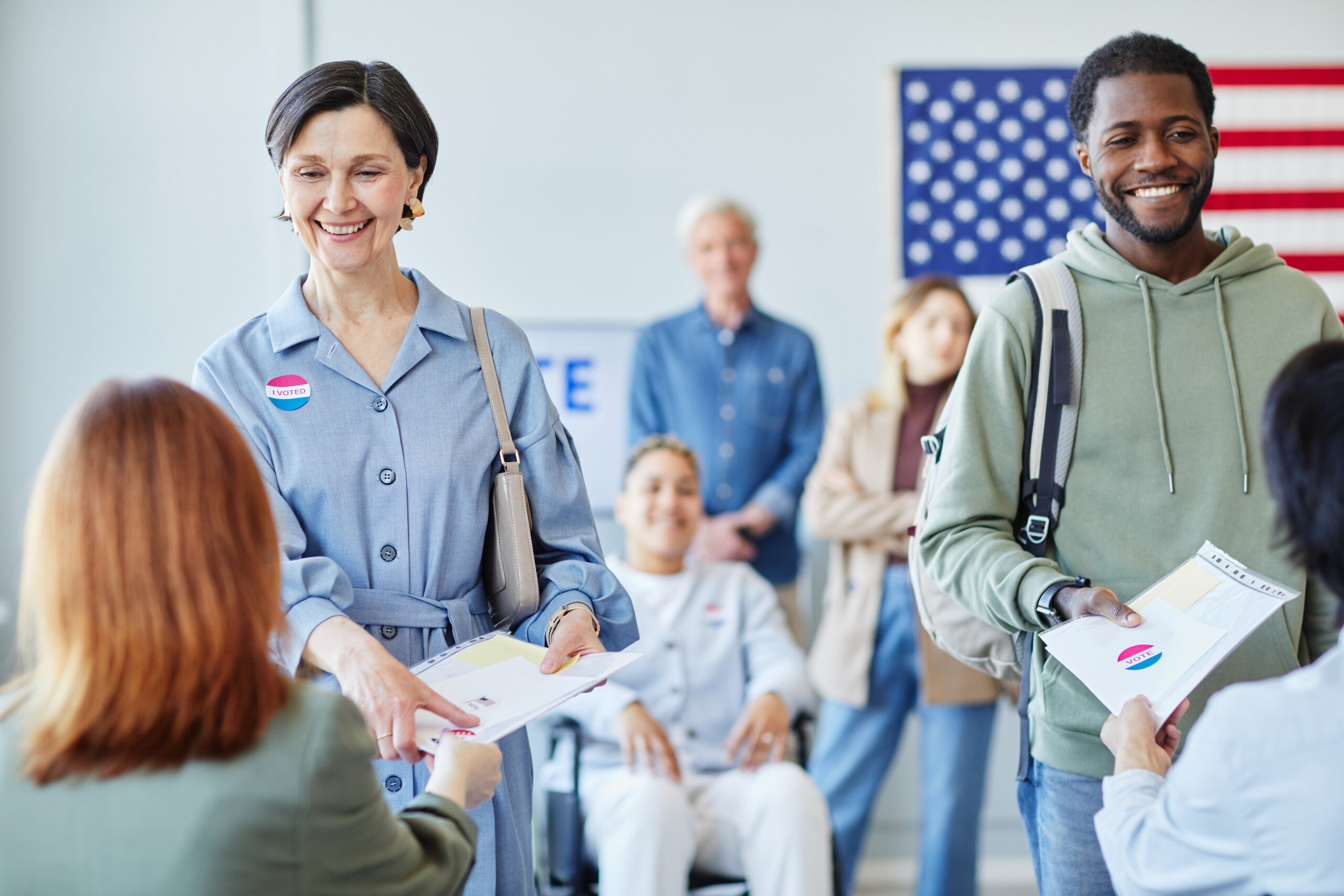 Smiling Voters Receiving Ballots